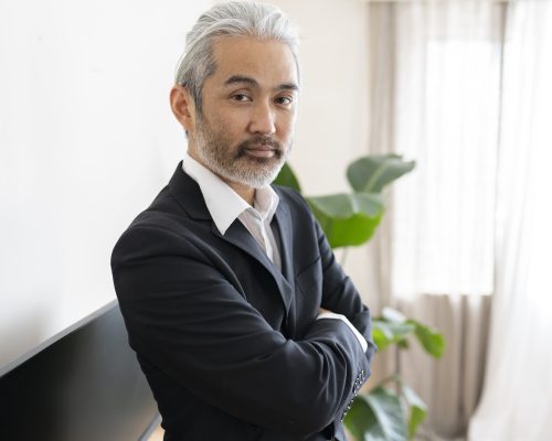 mature japanese businessman with gray hair in office